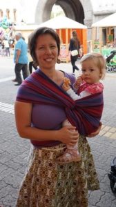 babywearing mama with baby