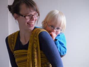 babywearing mama with her son