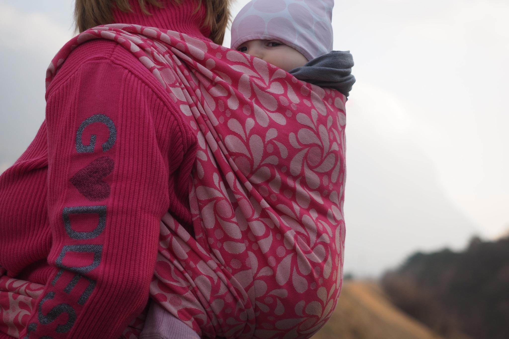 babywearing mama with Sveja pink fluffy woven wrap