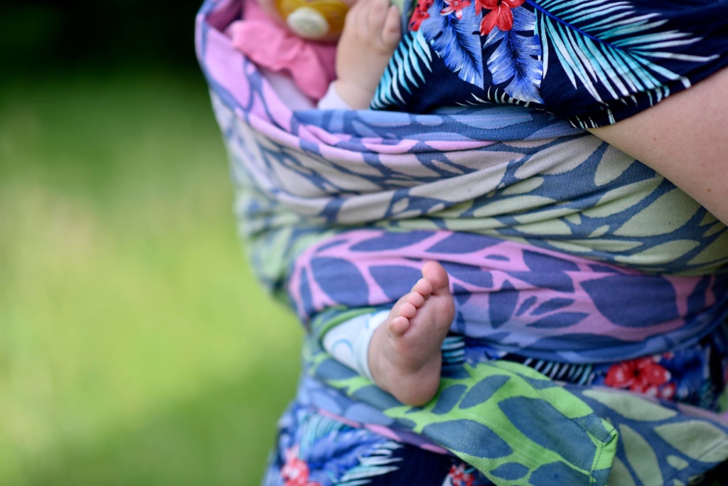 detail of Mama with Baby on her back in a woven baby wrap