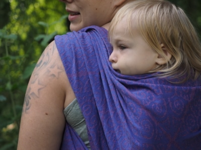 baby in a wrap on mamas back
